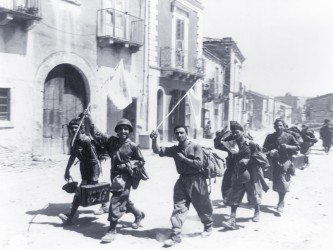Italian prisoners near Messina carry flags of surrender.